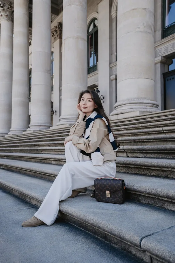 Portrait on the Nationaltheater steps in front of columns and arched windows.